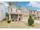 Two-story home with neutral siding, brick-accented facade, and a well-manicured front yard with landscaping at 2248 Newbury Oaks Dr, Lawrenceville, GA 30044