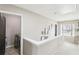Hallway with view into laundry room; features a white banister, and several framed pictures on the wall at 2248 Newbury Oaks Dr, Lawrenceville, GA 30044