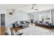 Bright living room features hardwood floors, gray sofas, contemporary decor, and large windows at 2248 Newbury Oaks Dr, Lawrenceville, GA 30044