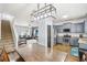 Bright open-concept living space featuring modern lighting, stainless steel appliances, and hardwood floors at 2248 Newbury Oaks Dr, Lawrenceville, GA 30044