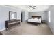 Spacious main bedroom featuring a geometric accent wall, large bed, dresser, and ceiling fan at 2248 Newbury Oaks Dr, Lawrenceville, GA 30044