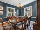 Traditional dining room with dark blue walls and classic wooden furniture at 582 Lakeshore Ne Dr, Atlanta, GA 30307
