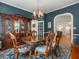 Formal dining room with blue walls, a large wooden table, and ornate china cabinet at 582 Lakeshore Ne Dr, Atlanta, GA 30307