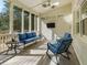 Inviting screened-in porch features a ceiling fan, comfortable seating and natural light at 582 Lakeshore Ne Dr, Atlanta, GA 30307