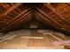Image shows the attic with insulation and exposed wooden rafters at 984 Cascade Sw Rd, Atlanta, GA 30311