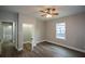 Bedroom featuring a large window, an adjacent closet, hardwood floors, and a ceiling fan at 984 Cascade Sw Rd, Atlanta, GA 30311