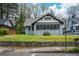 Charming home featuring a screened-in front porch, stone wall, and beautifully maintained lawn at 984 Cascade Sw Rd, Atlanta, GA 30311
