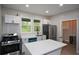 Charming kitchen with white cabinets, stainless steel appliances, and stylish center island at 984 Cascade Sw Rd, Atlanta, GA 30311