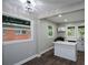 Eat-in kitchen with updated lighting, new floors, a kitchen island, and bright white cabinets at 984 Cascade Sw Rd, Atlanta, GA 30311