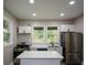 Modern kitchen with stainless steel appliances, an island, and bright, clean finishes at 984 Cascade Sw Rd, Atlanta, GA 30311