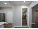 Hallway view of a staircase with wood steps and white railings at 984 Cascade Sw Rd, Atlanta, GA 30311