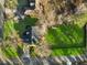 An aerial view of this home's large backyard with mature trees, a covered patio, and an outdoor living space at 1206 Red Fox Cir, Woodstock, GA 30188