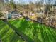 Aerial view of a home showcasing its spacious yard, patio, mature trees, and a shed at 1206 Red Fox Cir, Woodstock, GA 30188