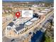 Aerial view of commercial properties in a community showcasing a mix of buildings and convenient parking, marked by a location pin at 1206 Red Fox Cir, Woodstock, GA 30188