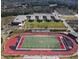 Aerial view of a school, stadium, and sports fields surrounded by a beautiful landscaped campus at 1206 Red Fox Cir, Woodstock, GA 30188
