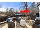 Outdoor patio with comfortable seating, a fire pit, and lush backyard views at 1206 Red Fox Cir, Woodstock, GA 30188