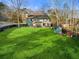 Spacious backyard with a patio area, shed, and well-maintained lawn, ideal for entertaining and relaxation at 1206 Red Fox Cir, Woodstock, GA 30188