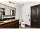 Bathroom featuring shiplap walls, dark wood door, and a large granite vanity at 1206 Red Fox Cir, Woodstock, GA 30188