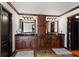 Dual vanities in the primary bathroom with dark cabinets, stone countertops, and ample storage at 1206 Red Fox Cir, Woodstock, GA 30188