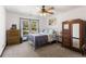 Cozy bedroom with natural light, a ceiling fan, and neutral carpet flooring at 1206 Red Fox Cir, Woodstock, GA 30188