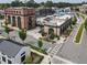 Commercial area featuring brick buildings, ample parking, inviting outdoor seating and pedestrian-friendly crosswalks at 1206 Red Fox Cir, Woodstock, GA 30188
