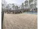 A covered outdoor gathering space with picnic tables and a tennis court in the background at 1206 Red Fox Cir, Woodstock, GA 30188