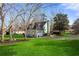 Charming home featuring a well-manicured lawn, mature trees, and an attached two-car garage at 1206 Red Fox Cir, Woodstock, GA 30188