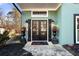 Elegant double front doors flanked by lights and planters create a welcoming entrance at 1206 Red Fox Cir, Woodstock, GA 30188