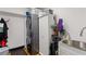Well-equipped laundry room features a stacked washer and dryer, sink, and cabinet storage at 1206 Red Fox Cir, Woodstock, GA 30188