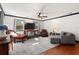 Inviting living room showcasing a ceiling fan, tv, and beautiful floors at 1206 Red Fox Cir, Woodstock, GA 30188
