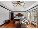 Spacious main bedroom featuring a ceiling fan, tray ceiling, and an accent chair at 1206 Red Fox Cir, Woodstock, GA 30188