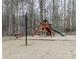 A wooden playground structure, with swings and a slide, set in a fenced-in area at 1206 Red Fox Cir, Woodstock, GA 30188