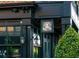 Exterior of a restaurant with dark trim and elegant signage, complemented by manicured landscaping and charming lighting at 1206 Red Fox Cir, Woodstock, GA 30188