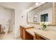 The bathroom vanity features granite countertops, lots of light, mirror, and tiled floor and walls at 213 The South Chace Ne, Sandy Springs, GA 30328