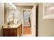The powder room features a vanity with granite countertops, mirror, and a staircase in the background at 213 The South Chace Ne, Sandy Springs, GA 30328