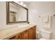 The bathroom features a large mirror over a vanity with granite counters, tiled floor, and white walls at 213 The South Chace Ne, Sandy Springs, GA 30328