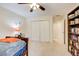 Bedroom featuring plush carpeting, ceiling fan, artwork, closet, and built-in bookcase at 213 The South Chace Ne, Sandy Springs, GA 30328