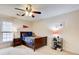 Bedroom featuring plush carpeting, ceiling fan, window, and a wood bed with matching nightstand at 213 The South Chace Ne, Sandy Springs, GA 30328