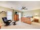 Neutral bedroom with plush carpeting, ceiling fan, two large windows, wood furniture, and a comfortable reading chair at 213 The South Chace Ne, Sandy Springs, GA 30328
