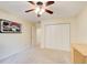 Bedroom featuring plush carpeting, ceiling fan, artwork, and a large closet with folding doors at 213 The South Chace Ne, Sandy Springs, GA 30328
