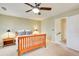 Bedroom with plush carpeting, ceiling fan, wood furniture, and a doorway leading to the hallway at 213 The South Chace Ne, Sandy Springs, GA 30328