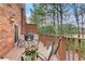 Inviting outdoor deck featuring charming seating and peaceful views of the surrounding wooded area at 213 The South Chace Ne, Sandy Springs, GA 30328
