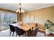 Bright dining room featuring hardwood floors, neutral paint, modern chandelier, and a sliding glass door at 213 The South Chace Ne, Sandy Springs, GA 30328