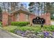 Community entrance sign surrounded by landscaped gardens and greenery at 213 The South Chace Ne, Sandy Springs, GA 30328