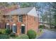 Charming brick townhome featuring a well-maintained front yard with lush greenery and a cozy entrance at 213 The South Chace Ne, Sandy Springs, GA 30328
