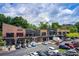 Exterior shot of a two-story brick building with multiple businesses and a full parking lot at 213 The South Chace Ne, Sandy Springs, GA 30328