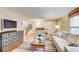 Spacious living room featuring hardwood floors, a stairway, neutral paint, and comfortable seating at 213 The South Chace Ne, Sandy Springs, GA 30328