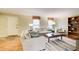 Bright living room featuring hardwood floors, a neutral sofa, an area rug, and bright windows at 213 The South Chace Ne, Sandy Springs, GA 30328