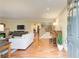 Open-concept living room featuring hardwood floors, neutral paint, comfortable seating, and a fireplace at 213 The South Chace Ne, Sandy Springs, GA 30328