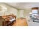 Comfortable living room featuring hardwood floors, a grand piano, neutral paint, and modern furnishings at 213 The South Chace Ne, Sandy Springs, GA 30328